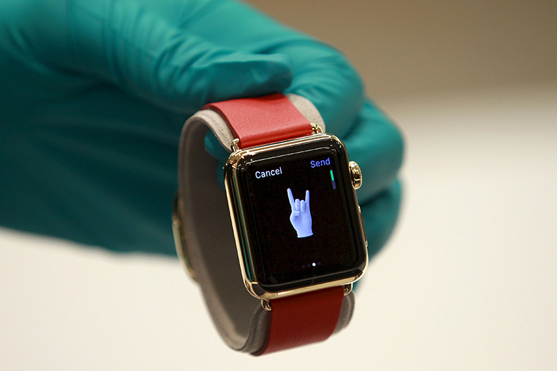 File photo of a sales assistant showing an Apple Watch Edition at an Apple reseller shop in Bangkok